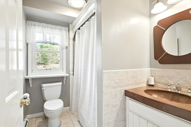 full bathroom featuring vanity, toilet, tile walls, tile patterned floors, and a baseboard radiator