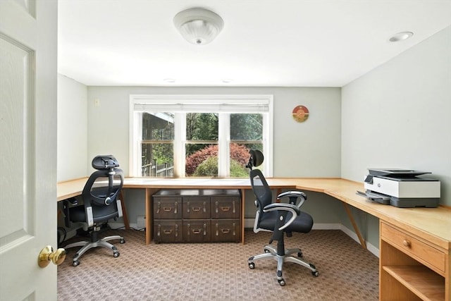 carpeted home office with built in study area