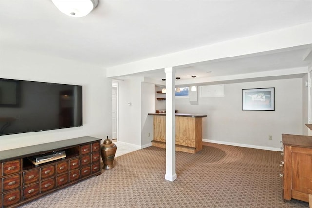 below grade area featuring a bar, carpet flooring, and baseboards