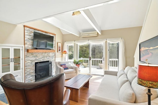 living area featuring a fireplace, wood finished floors, lofted ceiling, and a wall mounted air conditioner