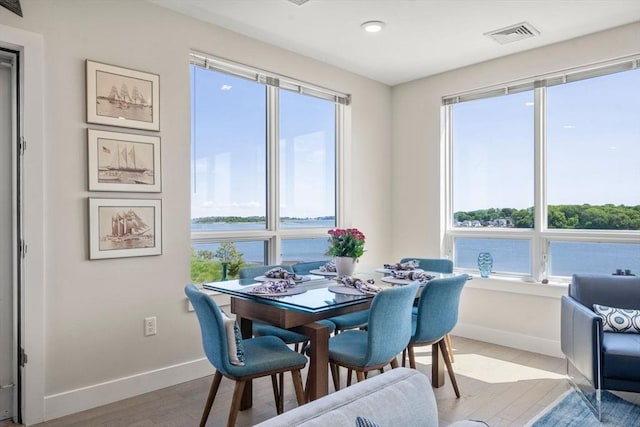 130 Broad Reach Unit 303, Weymouth, MA 02191 - dining space with baseboards, light wood-style floors, a water view, and recessed lighting