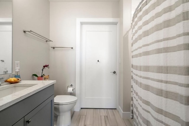 130 Broad Reach Unit 303, Weymouth, MA 02191 - bathroom with vanity, toilet, and wood finished floors