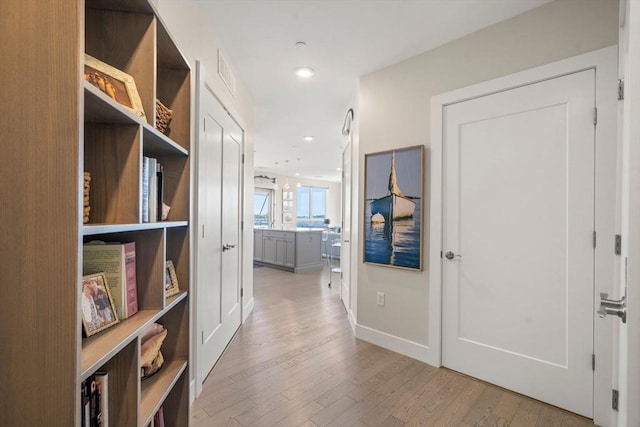 130 Broad Reach Unit 303, Weymouth, MA 02191 - hall featuring light wood finished floors, recessed lighting, and baseboards