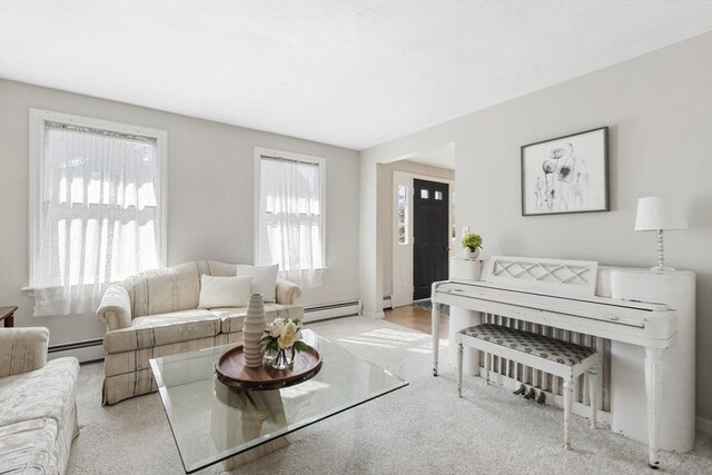 carpeted living area featuring baseboard heating and a baseboard heating unit