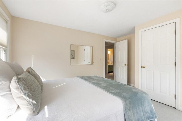 bedroom featuring light carpet