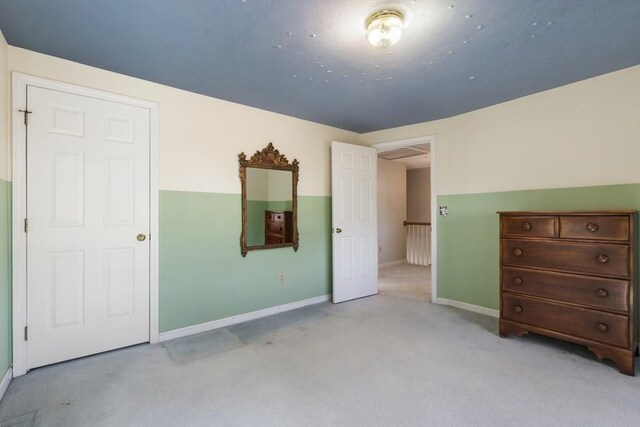 unfurnished bedroom with light carpet and baseboards