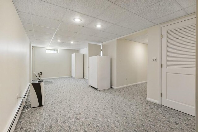 below grade area featuring carpet flooring, recessed lighting, baseboards, and freestanding refrigerator