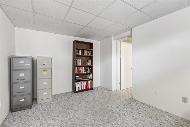 interior space featuring a drop ceiling and carpet