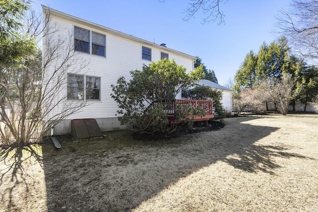 rear view of property featuring a wooden deck