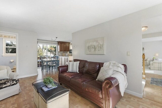 living room with light wood-style flooring and baseboards