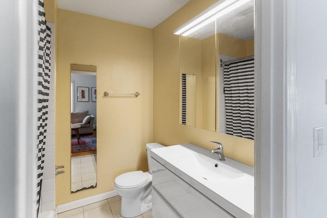 bathroom featuring toilet, vanity, and tile patterned floors