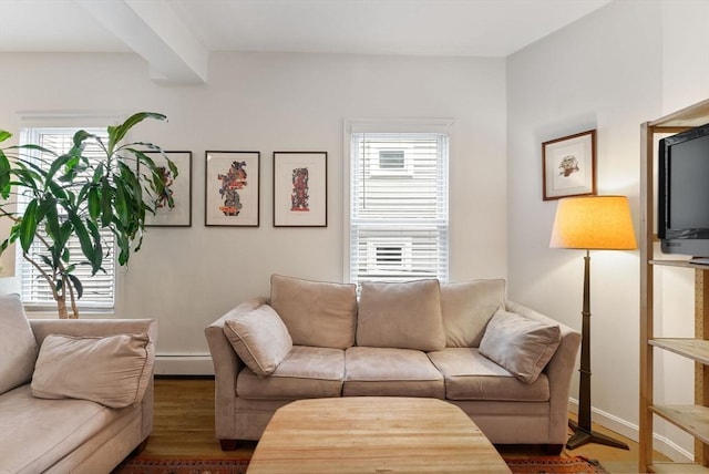 living room featuring beam ceiling, a baseboard radiator, and dark wood-type flooring