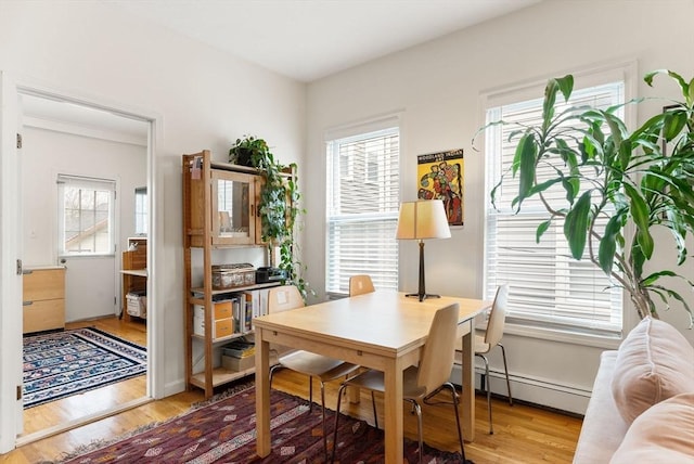 interior space with light wood-type flooring and a baseboard radiator