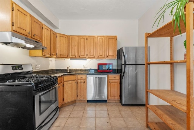 kitchen featuring light brown cabinetry, light tile patterned floors, sink, and appliances with stainless steel finishes