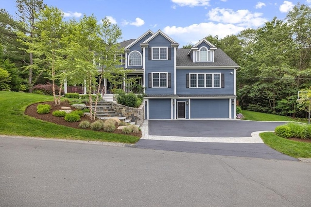 22 Flintlock Rd, Lexington, MA 02420 - view of front of house featuring stairs, an attached garage, driveway, a balcony, and a front yard