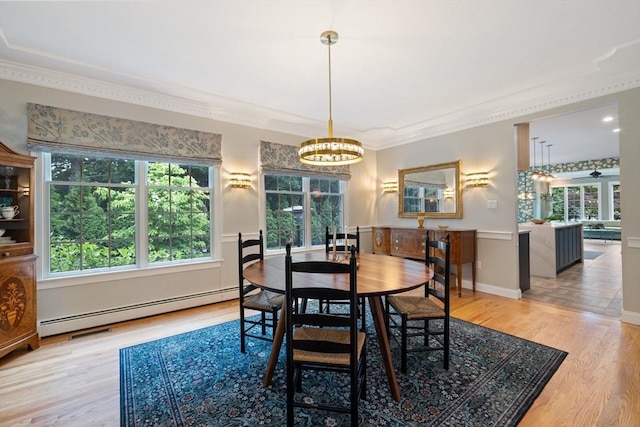 22 Flintlock Rd, Lexington, MA 02420 - dining room with a baseboard heating unit, wood finished floors, a chandelier, and crown molding