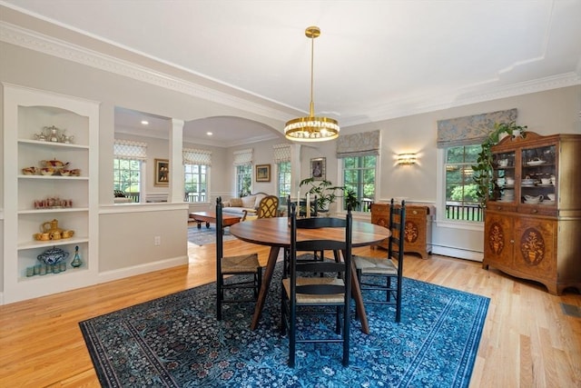 22 Flintlock Rd, Lexington, MA 02420 - dining room featuring baseboard heating, decorative columns, a chandelier, wood finished floors, and plenty of natural light
