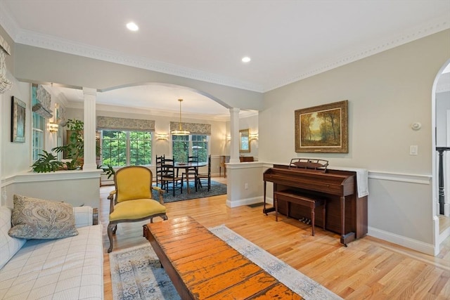 22 Flintlock Rd, Lexington, MA 02420 - living area featuring decorative columns, arched walkways, light wood-style flooring, crown molding, and recessed lighting
