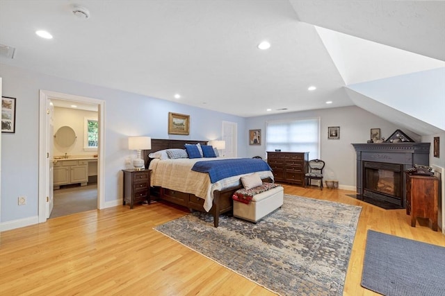 22 Flintlock Rd, Lexington, MA 02420 - bedroom with light wood-type flooring, recessed lighting, and a fireplace with flush hearth