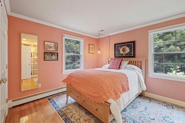 22 Flintlock Rd, Lexington, MA 02420 - bedroom featuring baseboard heating, multiple windows, wood finished floors, and crown molding