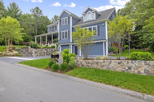 22 Flintlock Rd, Lexington, MA 02420 - view of front facade with a garage, a front lawn, and driveway