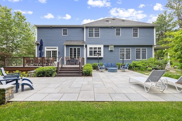 22 Flintlock Rd, Lexington, MA 02420 - rear view of house featuring a deck, a patio area, and an outdoor hangout area