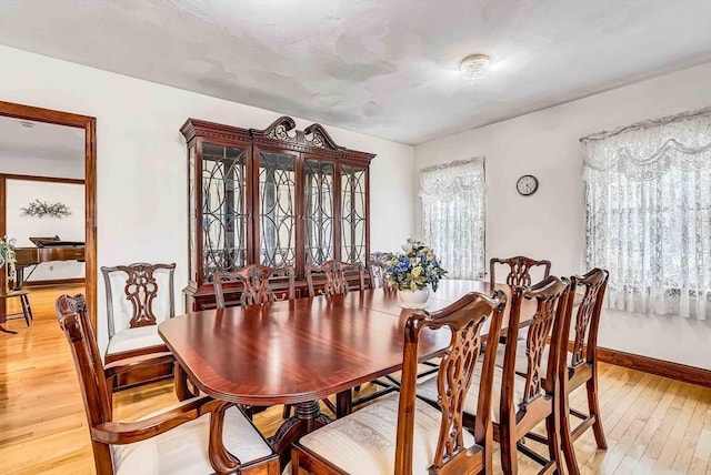 dining room with light wood-style floors and baseboards
