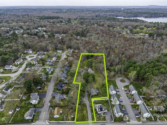 birds eye view of property featuring a water view and a forest view