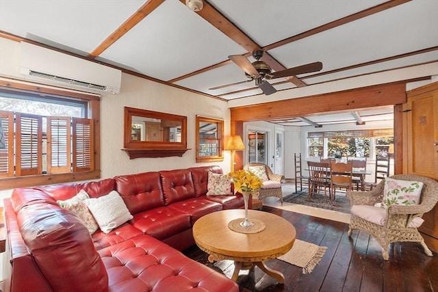 living area with a wall mounted AC, wood-type flooring, healthy amount of natural light, a ceiling fan, and beamed ceiling