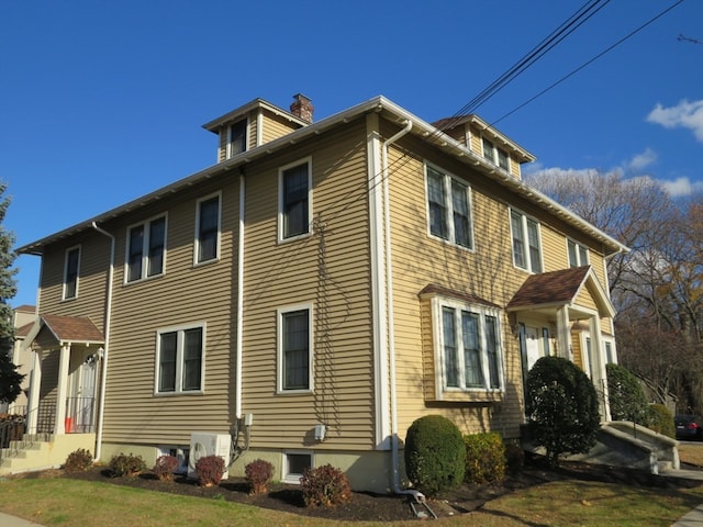 view of side of home featuring ac unit