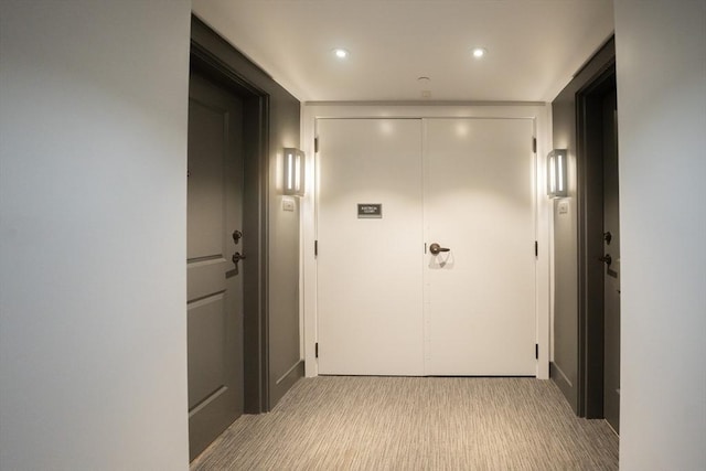 hallway with light colored carpet