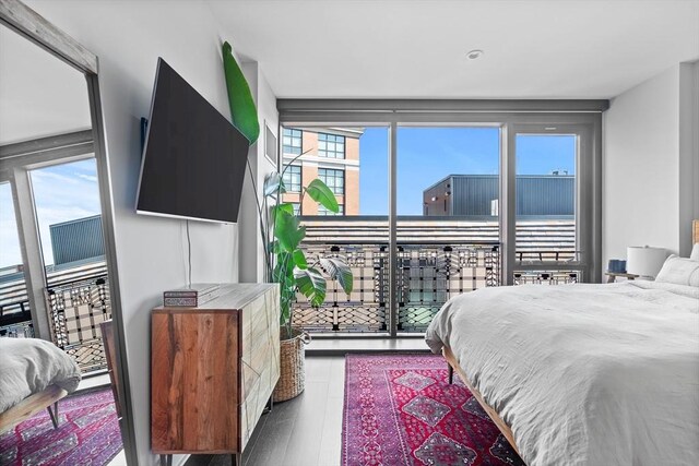 bedroom featuring multiple windows and hardwood / wood-style flooring