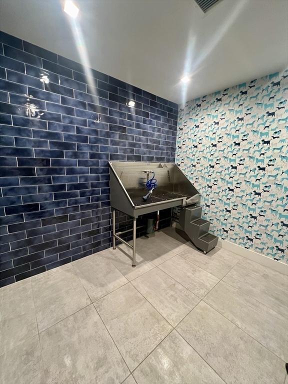 99 Sumner St Unit 307, Boston, MA 02128 - misc room featuring pet washing station, tile patterned floors, and tile walls