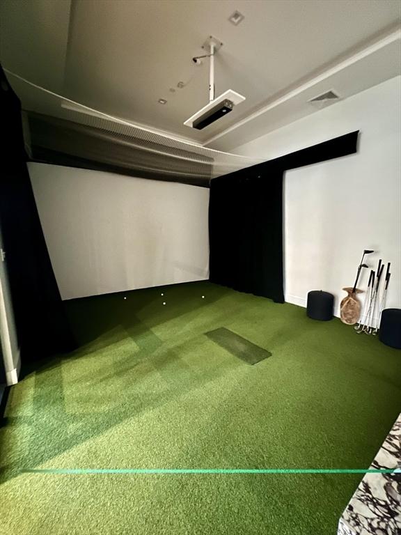 99 Sumner St Unit 307, Boston, MA 02128 - carpeted home theater with golf simulator