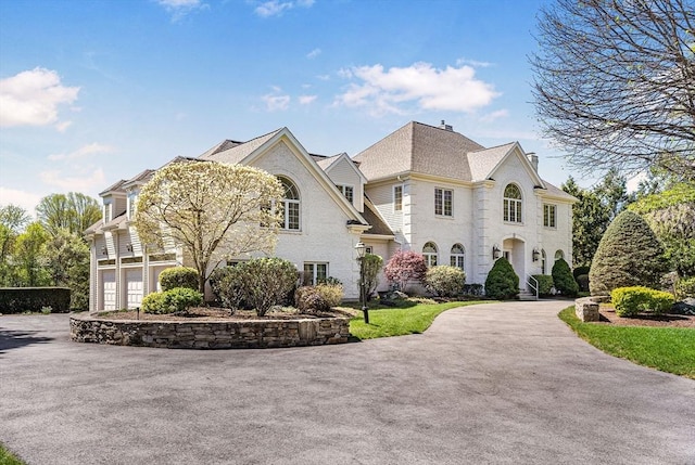 view of side of home featuring asphalt driveway