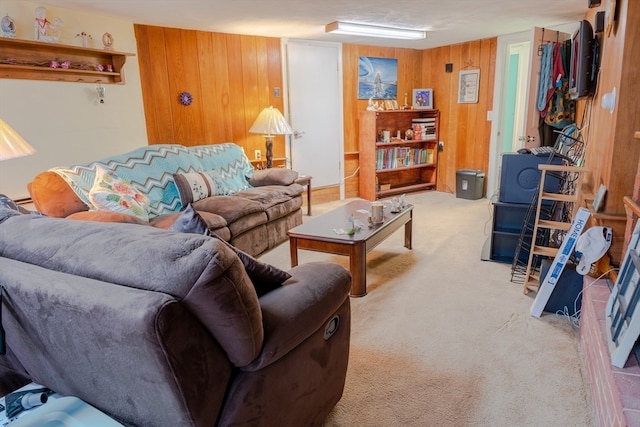 carpeted living room featuring wood walls