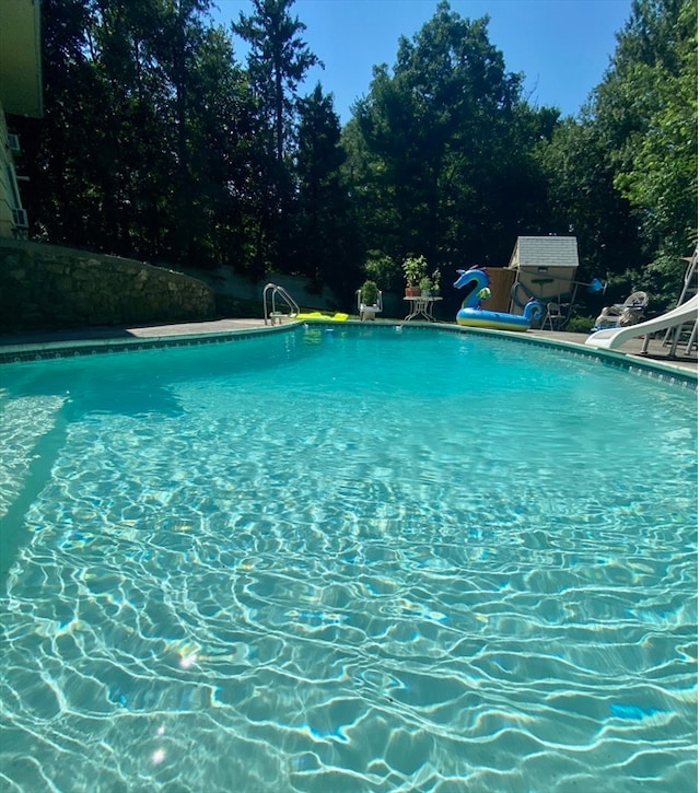 view of swimming pool featuring a water slide