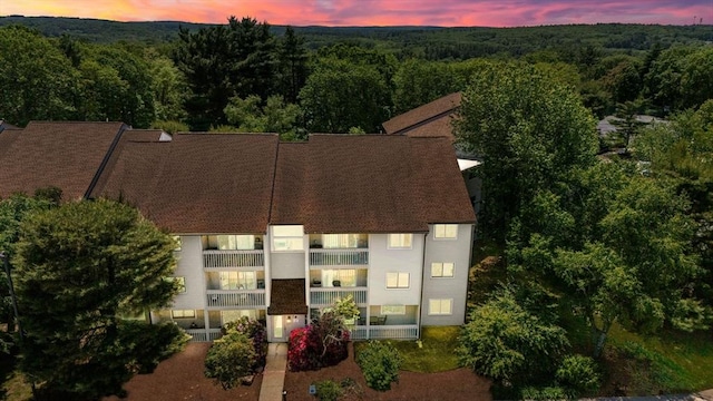 2012 Franklin Crossing Rd Unit 2012, Franklin, MA 02038 - property at dusk featuring a wooded view