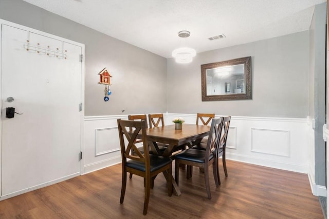 2012 Franklin Crossing Rd Unit 2012, Franklin, MA 02038 - dining room featuring a wainscoted wall, wood finished floors, and a decorative wall
