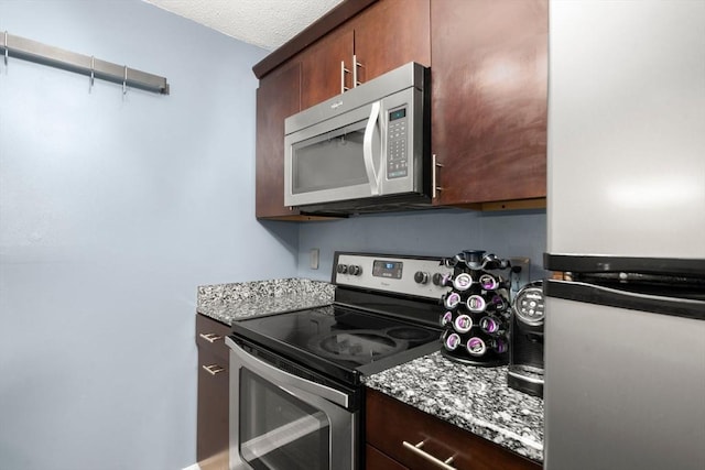 2012 Franklin Crossing Rd Unit 2012, Franklin, MA 02038 - kitchen with appliances with stainless steel finishes, dark brown cabinetry, and light stone counters