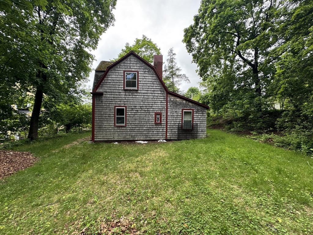 54 Plymouth St, East Bridgewater, MA 02333 - back of house with a chimney and a yard