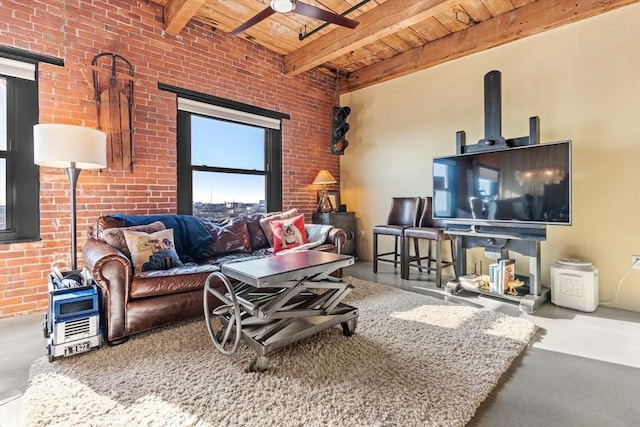 living room with ceiling fan, wooden ceiling, beamed ceiling, brick wall, and concrete flooring