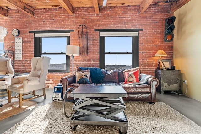 living room with beamed ceiling, concrete flooring, and a wealth of natural light