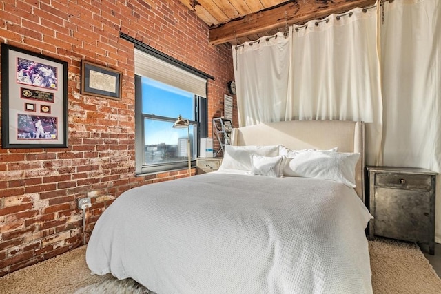 bedroom with carpet flooring, beam ceiling, wood ceiling, and brick wall