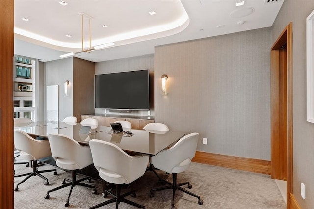 dining area featuring a raised ceiling