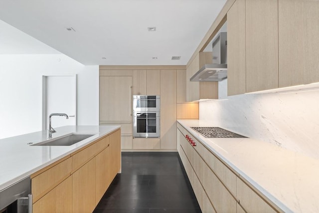 kitchen featuring light brown cabinetry, sink, and stainless steel double oven