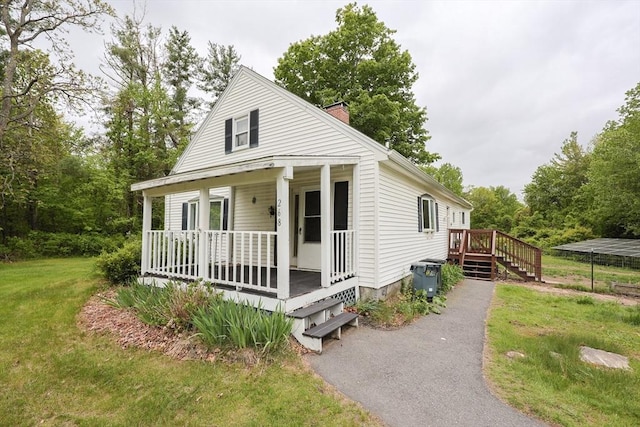 268 Wallace Hill Rd, Townsend, MA 01469 - view of front facade with a porch, a chimney, and a front yard