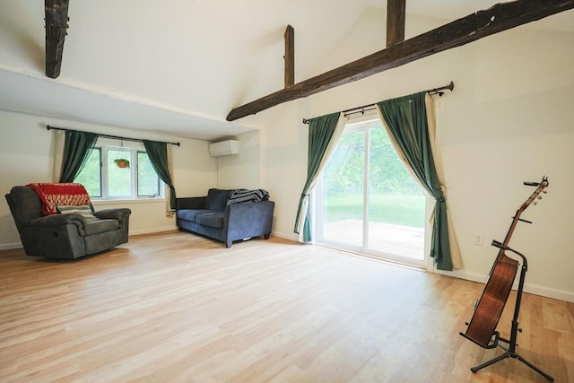 268 Wallace Hill Rd, Townsend, MA 01469 - living room with wood finished floors, plenty of natural light, an AC wall unit, baseboards, and high vaulted ceiling
