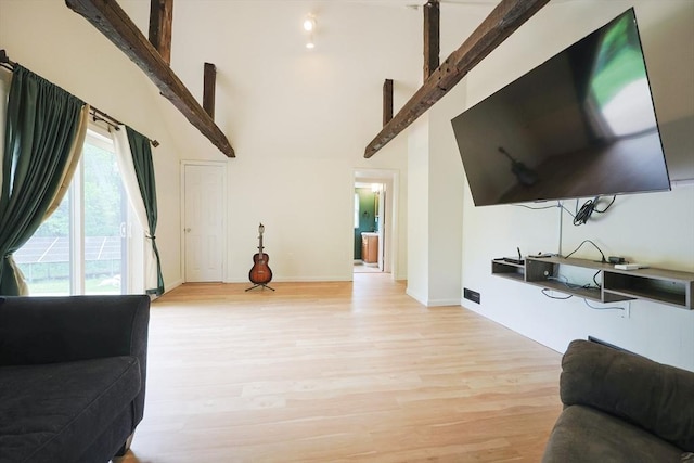 268 Wallace Hill Rd, Townsend, MA 01469 - living room with high vaulted ceiling, light wood finished floors, baseboards, and beam ceiling