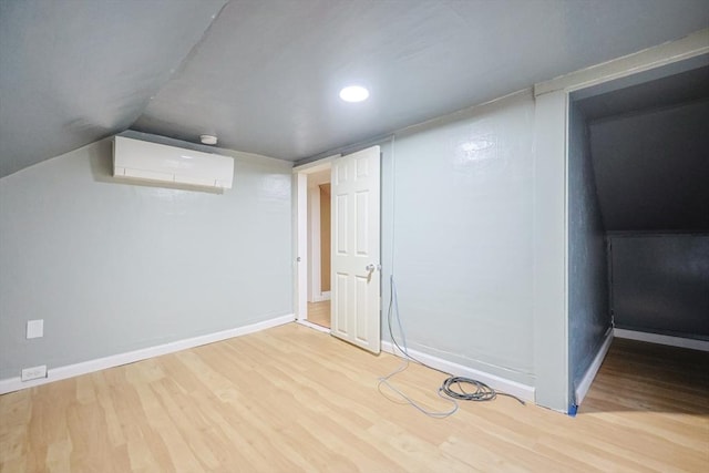 268 Wallace Hill Rd, Townsend, MA 01469 - below grade area with a wall mounted air conditioner, wood finished floors, baseboards, and recessed lighting